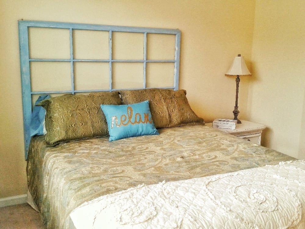 A Rustic Headboard Made From an Old Window Frame