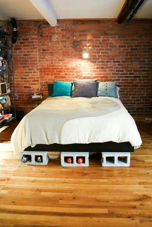 Use cinder blocks and plywood to make a low-cost storage bed