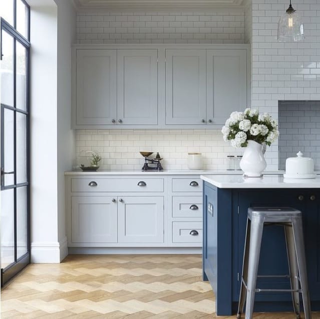 blue kitchen island with lighter blue upper cabinet
