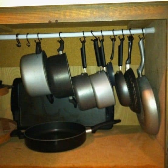 Under Kitchen Sink Storage Using Tension Rod To Store Pans